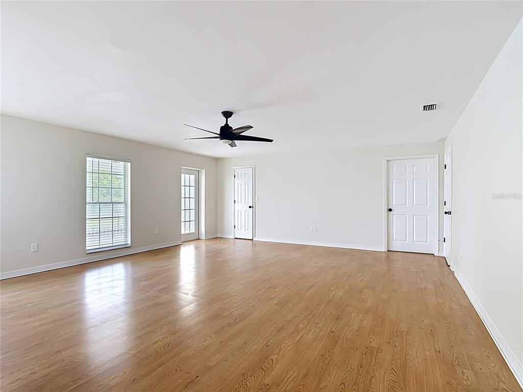 7925 Lake Mabel Loop Road Lake Wales, FL 33898 - Photo 27 of 97 a view of an empty room with a window and wooden floor
