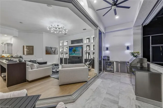 a living room with furniture and a chandelier