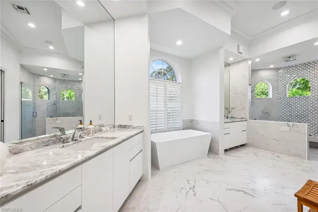 a spacious bathroom with a granite countertop tub sink and mirror
