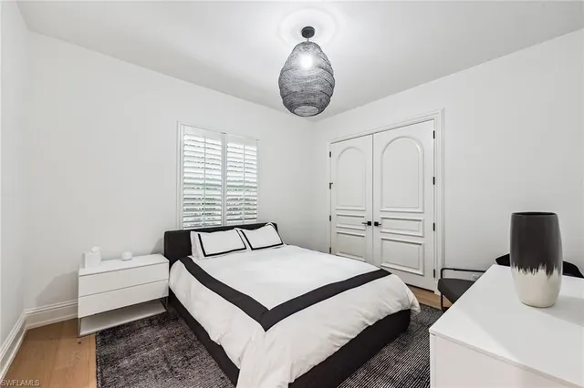 a bedroom with a bed and a chandelier