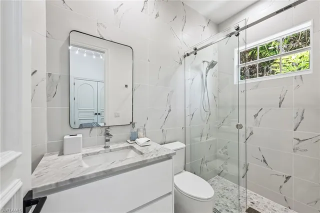 a bathroom with a sink toilet and shower