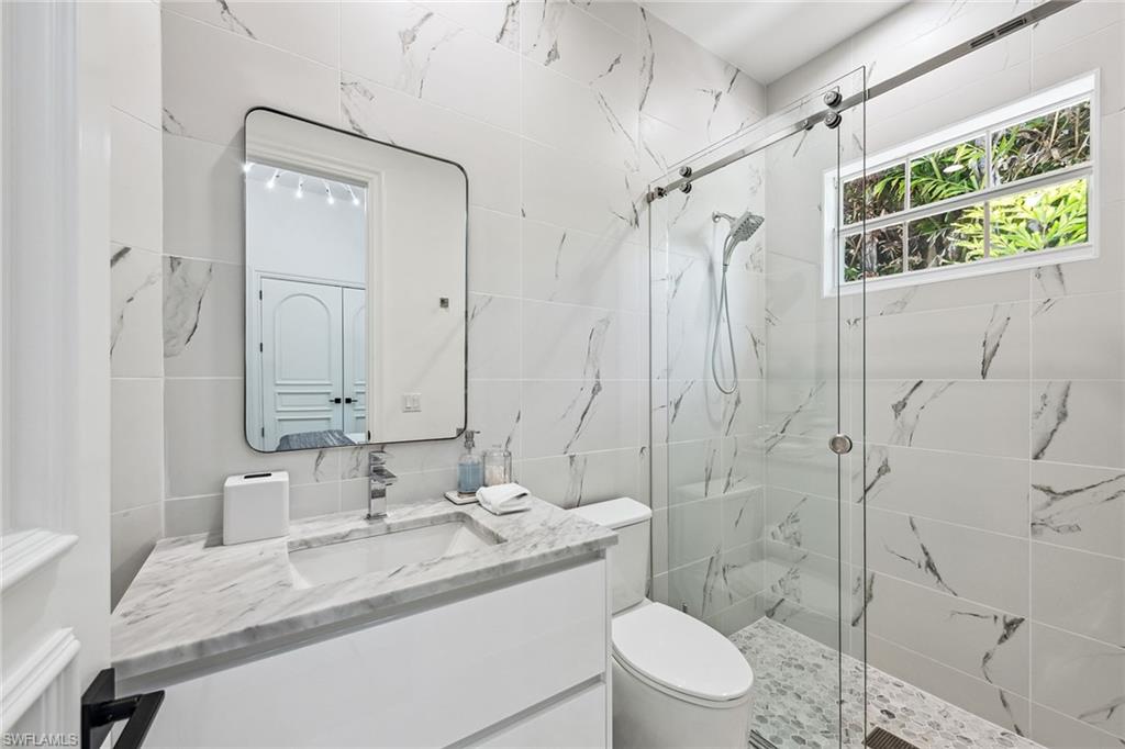 538 Riviera Drive Naples, FL 34103 - Photo 19 of 25 a bathroom with a sink toilet and shower