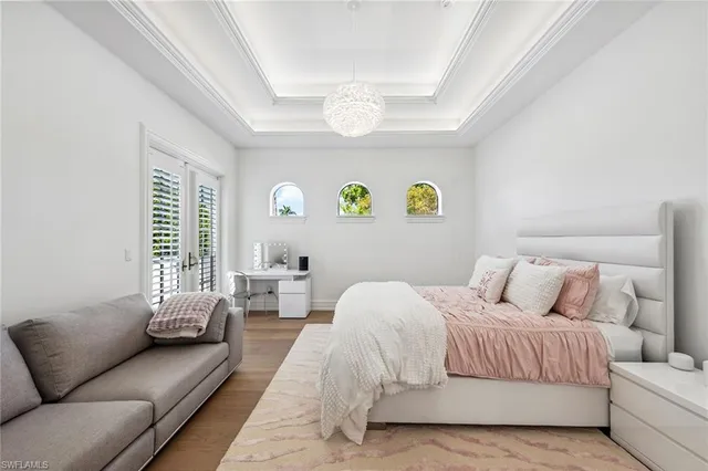 a bedroom with a bed couch and window