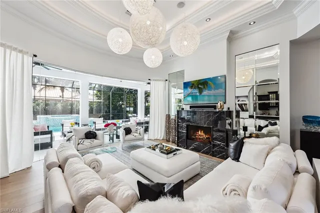 a living room with fireplace furniture and a large window