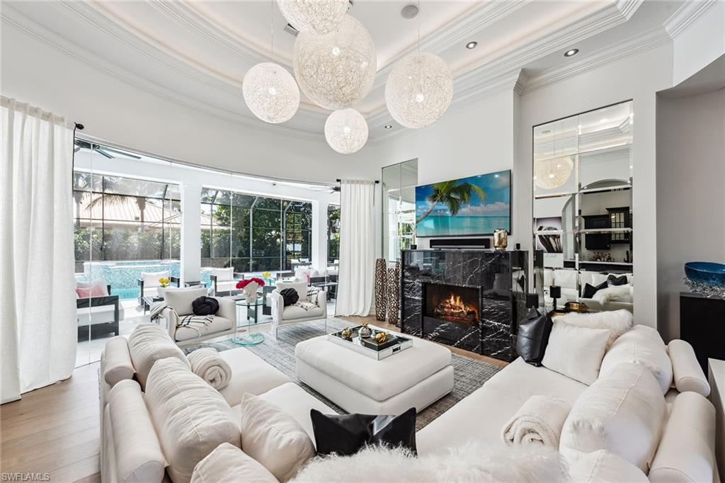 538 Riviera Drive Naples, FL 34103 - Photo 3 of 25 a living room with fireplace furniture and a large window