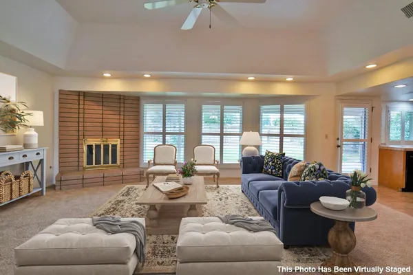 a kitchen with stainless steel appliances wooden cabinets a stove a microwave and a window