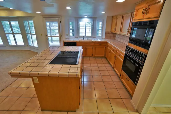 a spacious bathroom with a granite countertop sink a mirror and a