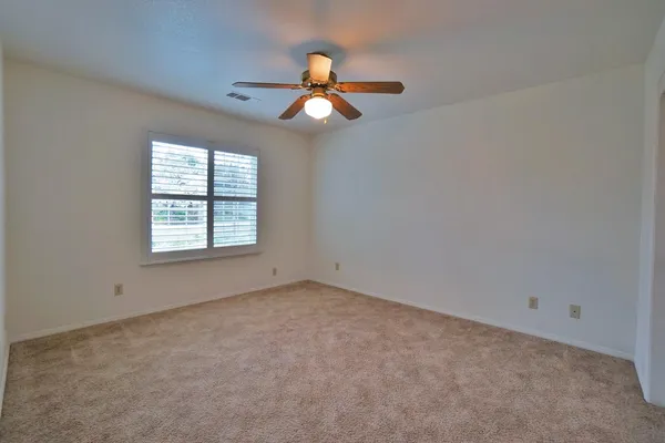 a view of a house with a wooden fence