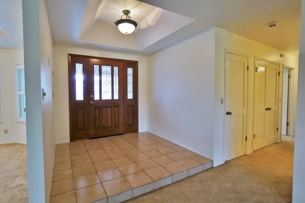an empty room with stairs and windows