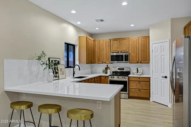 a kitchen with furniture a refrigerator and a sink
