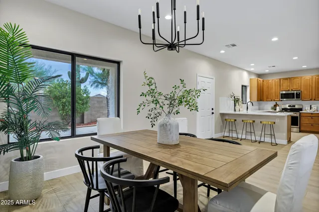 a dining room with furniture window and wooden floor