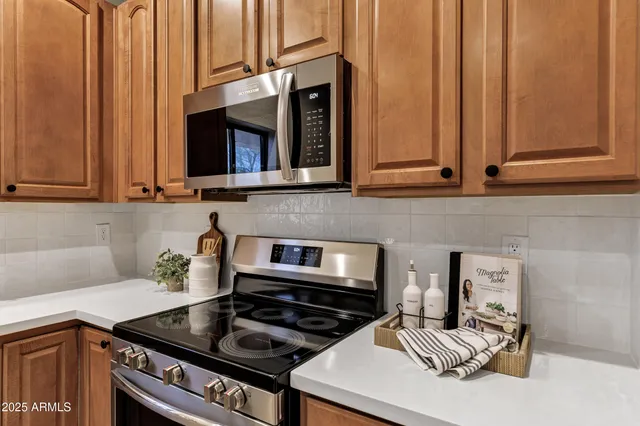 a kitchen with granite countertop a stove and a sink