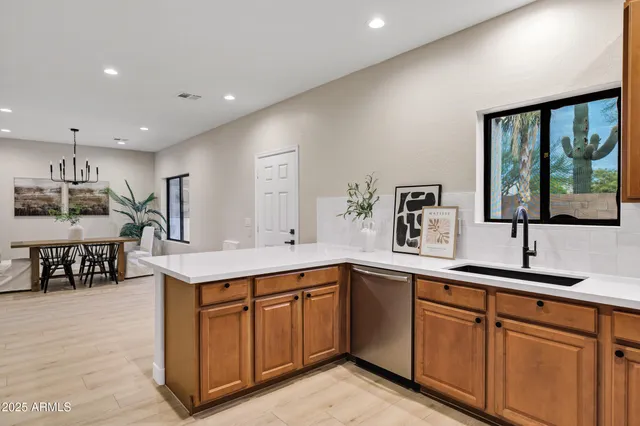 a kitchen with a sink cabinets and window