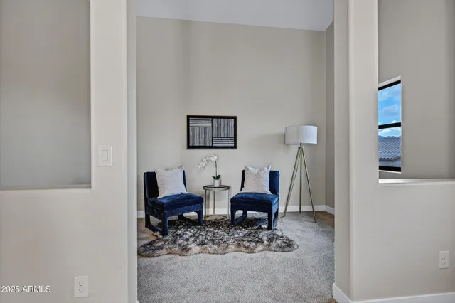 a living room with furniture and a painting on the wall