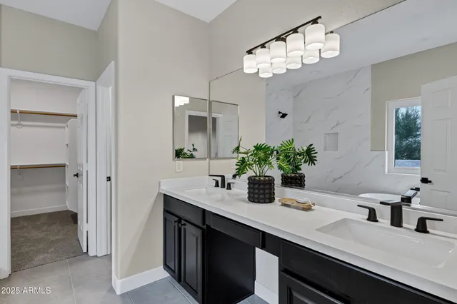 a bathroom with a granite countertop sink a light fixture and a mirror