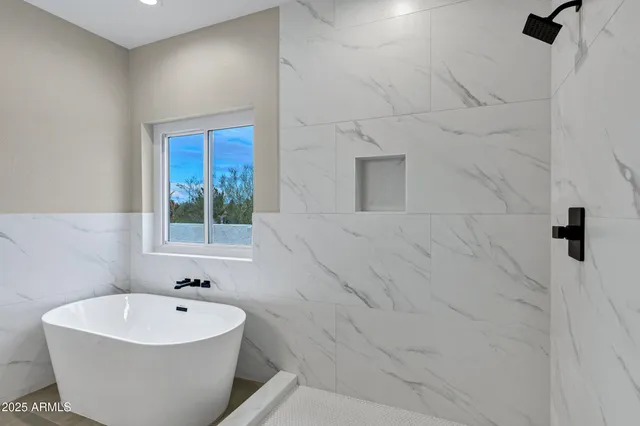 a white bath tub sitting in a bathroom