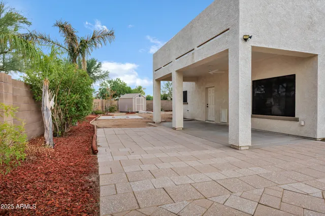 a view of a house with backyard and sitting area