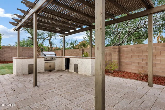 a view of a patio with table and chairs
