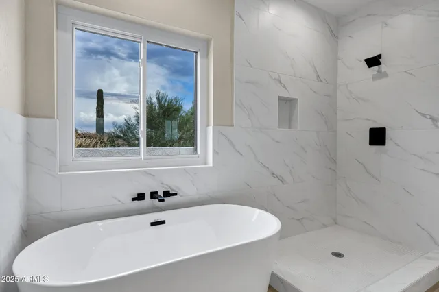 a bathroom with a bathtub and shower