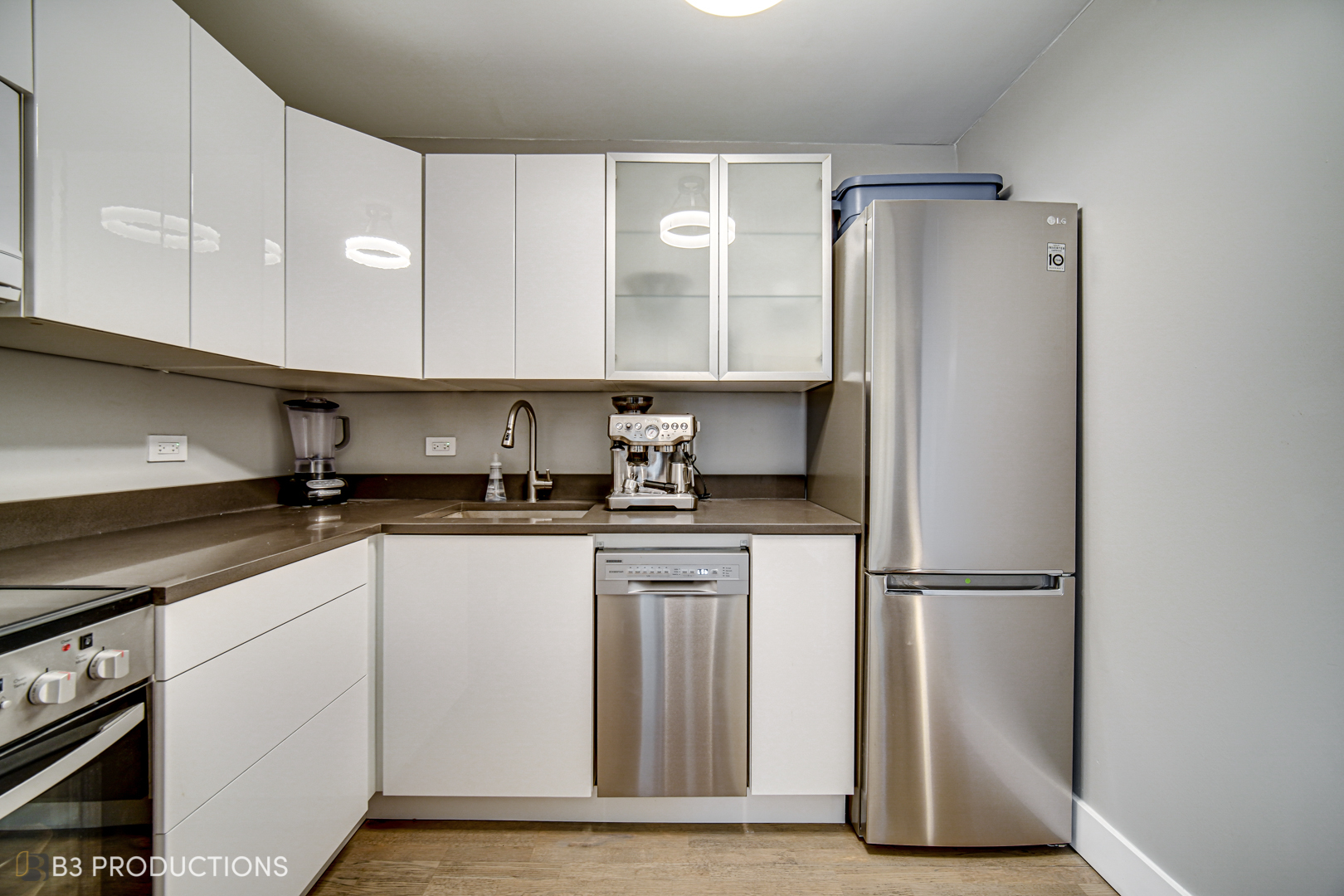 111 West Maple Street, Unit 3112 Chicago, IL 60610 - Photo 8 of 18 a kitchen with stainless steel appliances granite countertop a refrigerator a sink and white cabinets