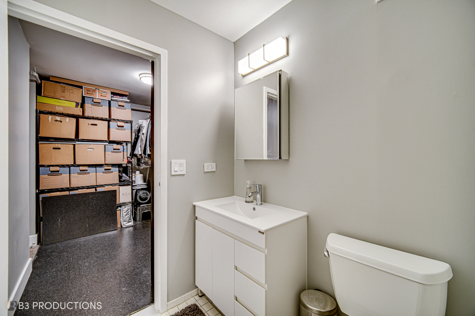 111 West Maple Street, Unit 3112 Chicago, IL 60610 - Photo 10 of 18 a bathroom with a toilet sink and mirror