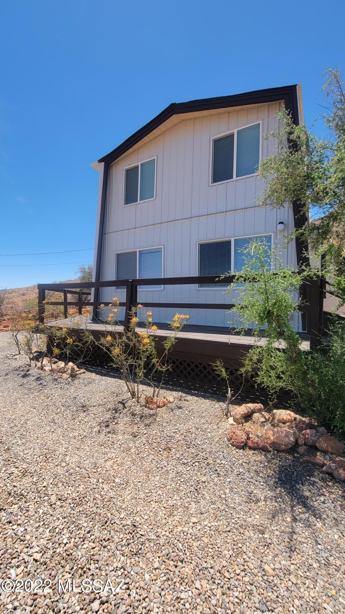 3399 Red Stag Road Pearce, AZ 85625 - Photo 44 of 47 a front view of a house with a yard