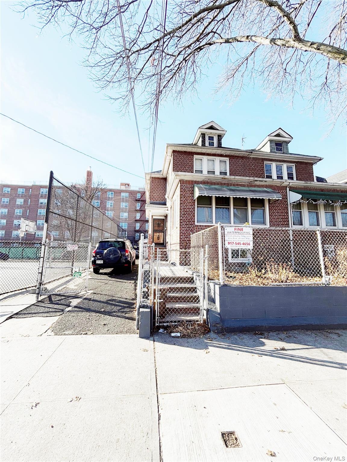 715 Rosedale Avenue Bronx, NY 10473 - Photo 1 of 1 American foursquare style home with a gate, a fenced front yard, and brick siding
