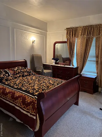 a bed sitting in a room next to a window