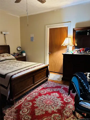 a bedroom with bed and flat screen tv
