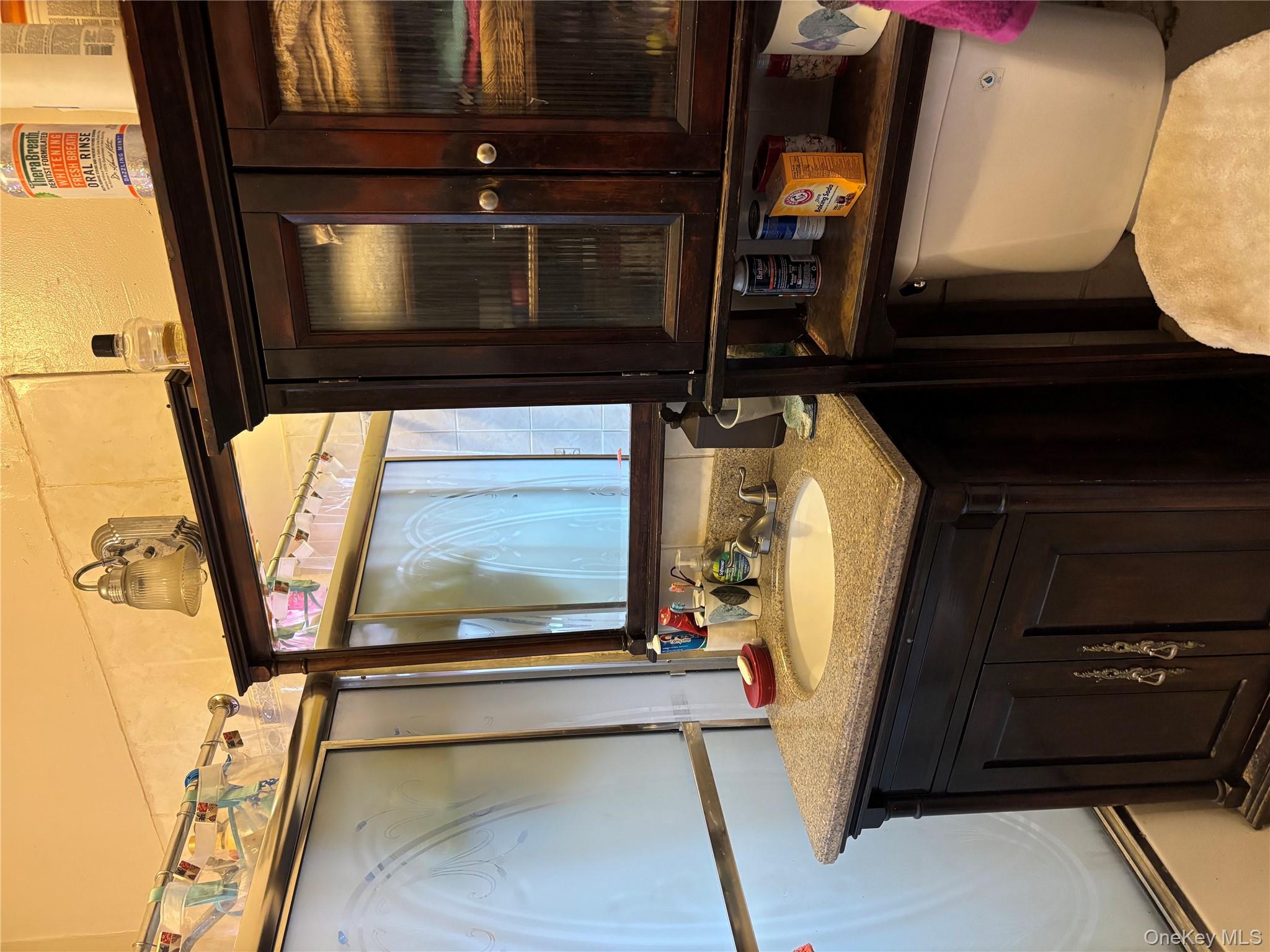715 Rosedale Avenue Bronx, NY 10473 - Photo 10 of 11 a bathroom with a sink and a mirror