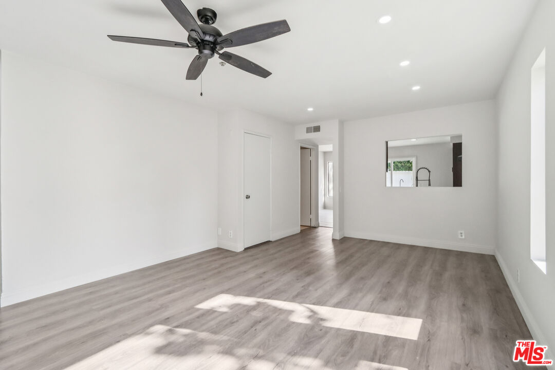 25885 Trabuco Road, Unit 226 Lake Forest, CA 92630 - Photo 11 of 23 wooden floor in an empty room with a window
