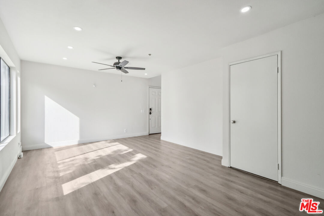 25885 Trabuco Road, Unit 226 Lake Forest, CA 92630 - Photo 12 of 23 wooden floor in an empty room with a window