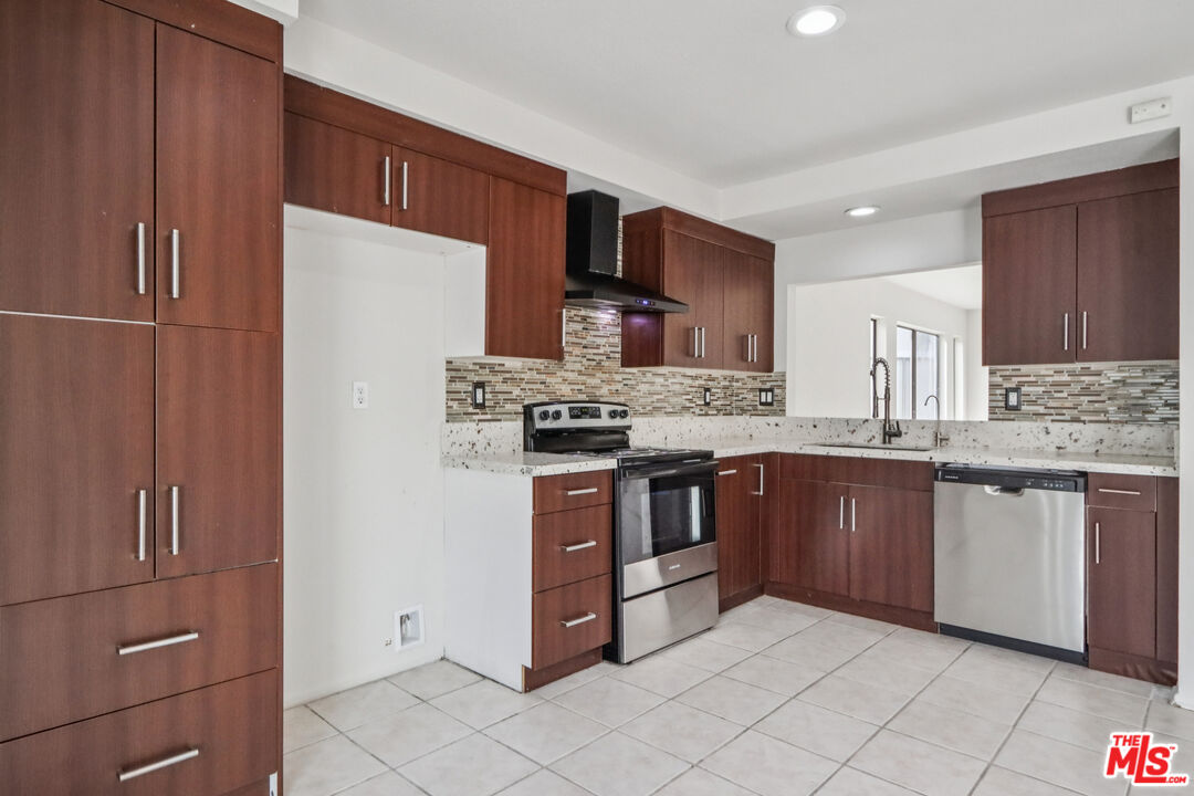 25885 Trabuco Road, Unit 226 Lake Forest, CA 92630 - Photo 14 of 23 a kitchen with stainless steel appliances granite countertop a refrigerator and a stove top oven