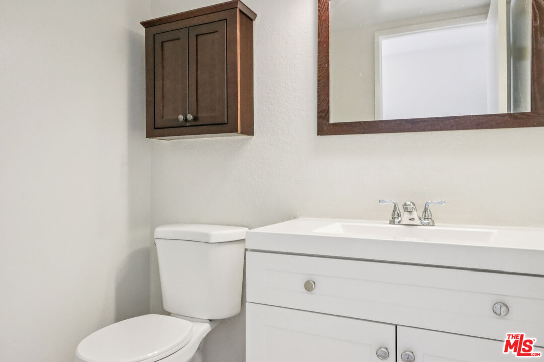 25885 Trabuco Road, Unit 226 Lake Forest, CA 92630 - Photo 17 of 23 a bathroom with a toilet sink and mirror
