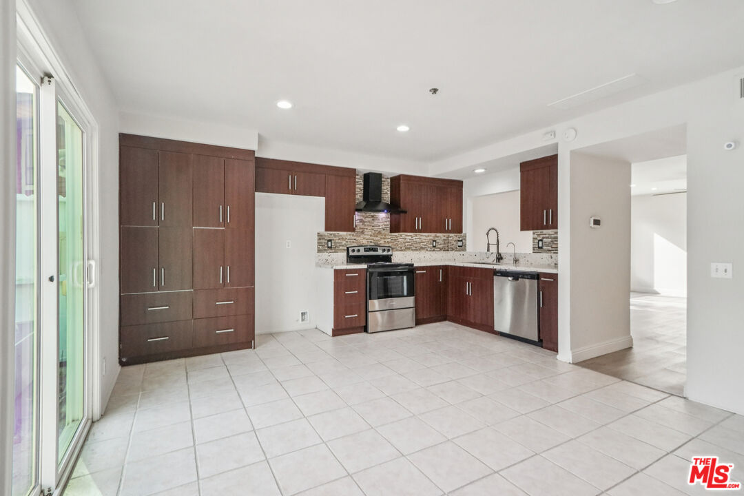 25885 Trabuco Road, Unit 226 Lake Forest, CA 92630 - Photo 4 of 23 a kitchen with stainless steel appliances granite countertop a refrigerator and a stove top oven