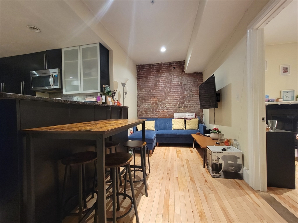 a kitchen with a table chairs and a refrigerator