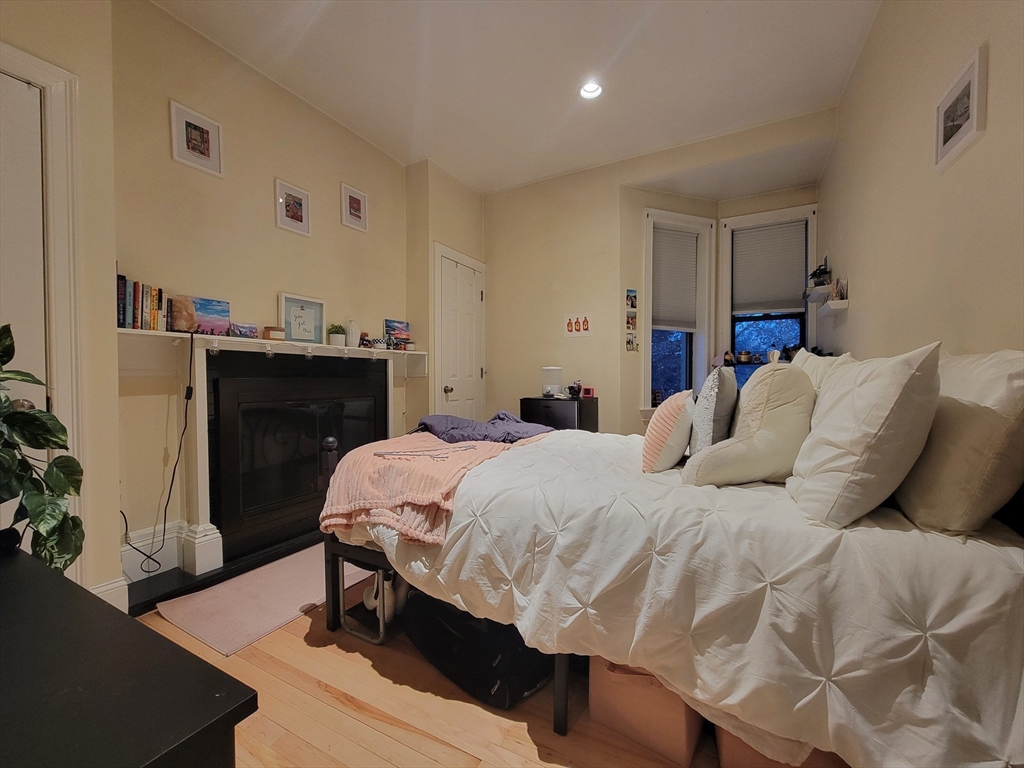 1203 Beacon Street, Unit 2 Brookline, MA 02446 - Photo 2 of 8 a bedroom with a bed and a table