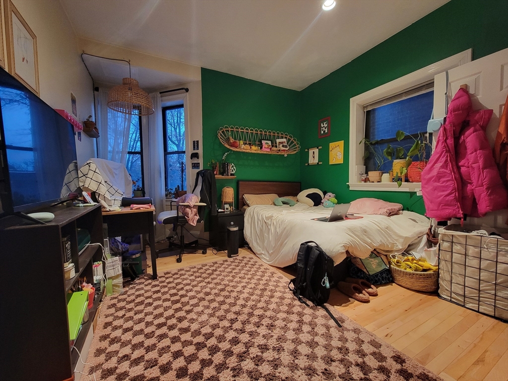 1203 Beacon Street, Unit 2 Brookline, MA 02446 - Photo 3 of 8 a bed room with a bed and a chair
