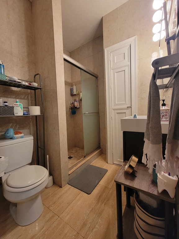 1203 Beacon Street, Unit 2 Brookline, MA 02446 - Photo 4 of 8 a bathroom with a toilet a sink and shower