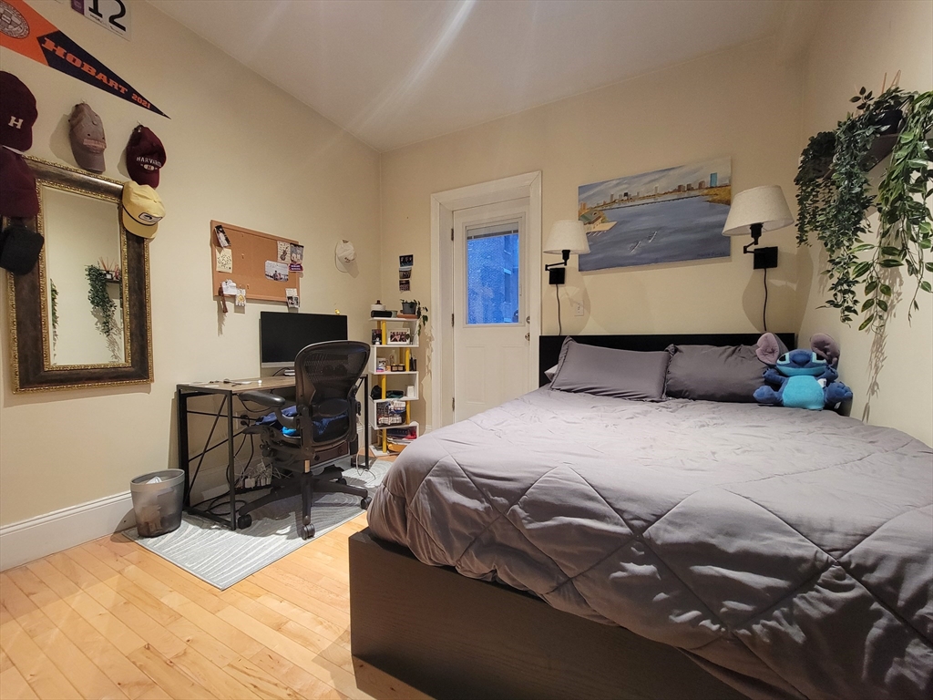1203 Beacon Street, Unit 2 Brookline, MA 02446 - Photo 5 of 8 a bedroom with a bed and wooden floor