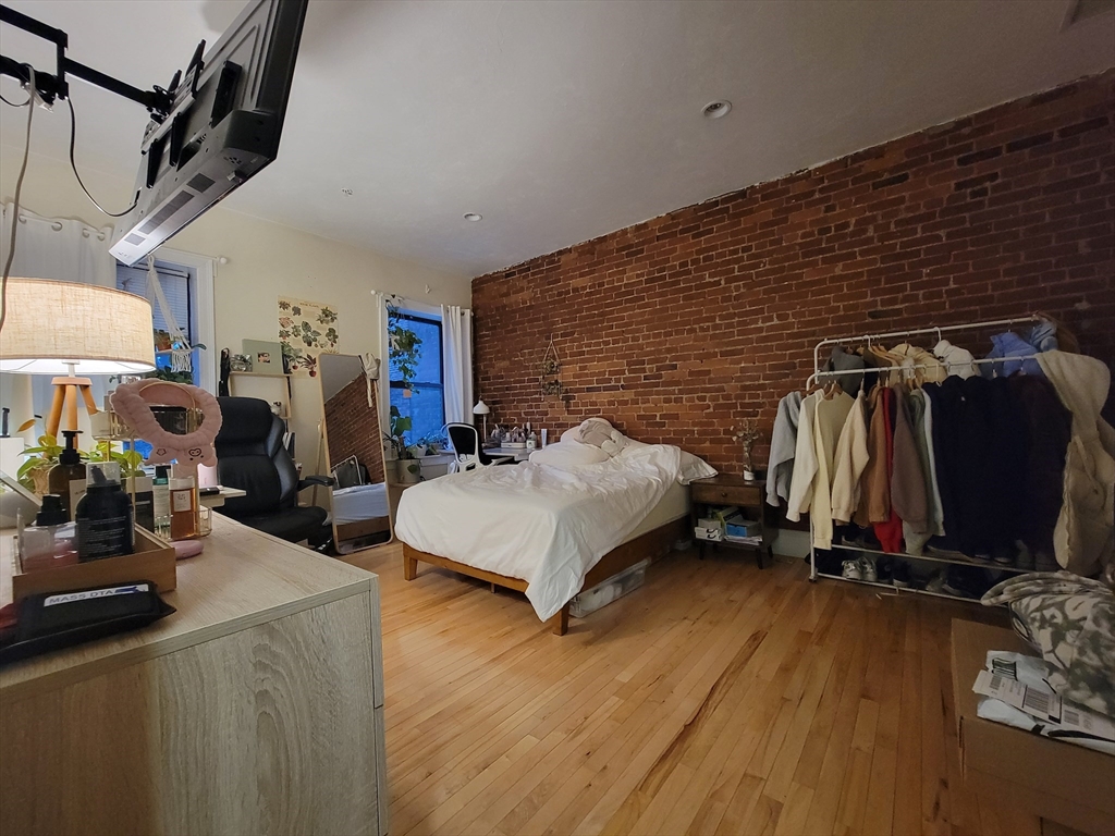 1203 Beacon Street, Unit 2 Brookline, MA 02446 - Photo 6 of 8 a bedroom with bed and a walk in closet