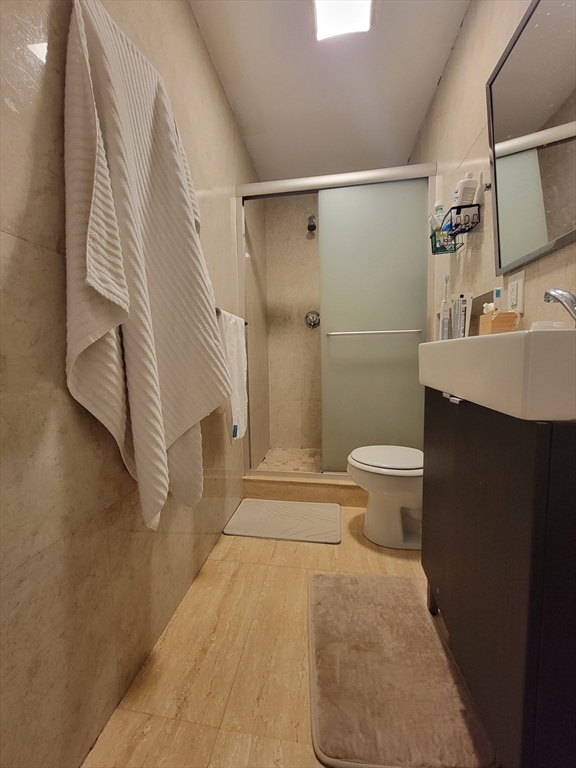 1203 Beacon Street, Unit 2 Brookline, MA 02446 - Photo 8 of 8 a bathroom with a sink toilet and shower