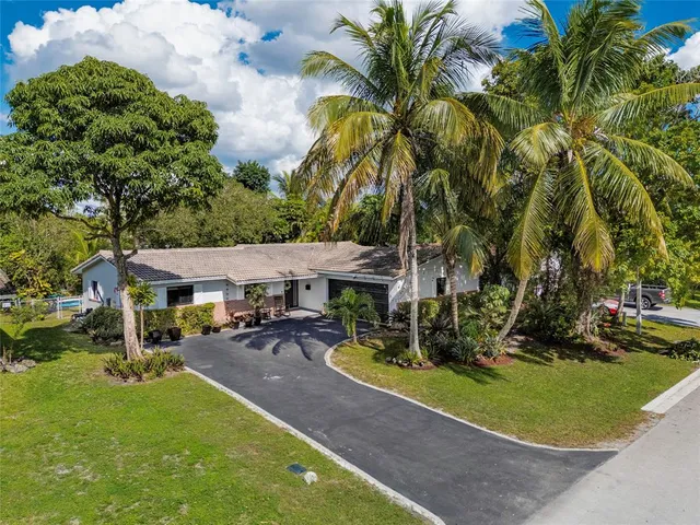 an aerial view of a house with a garden and plants