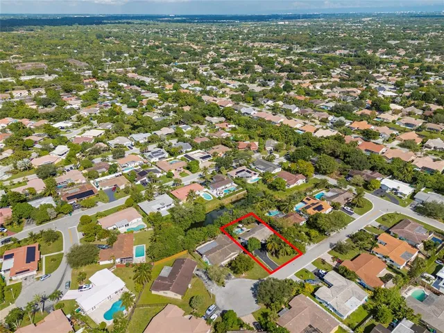 an aerial view of residential houses with outdoor space