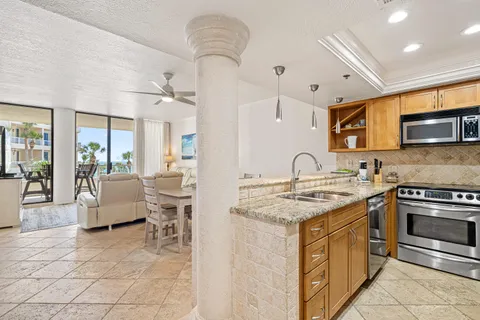a kitchen with stainless steel appliances granite countertop a stove and a sink