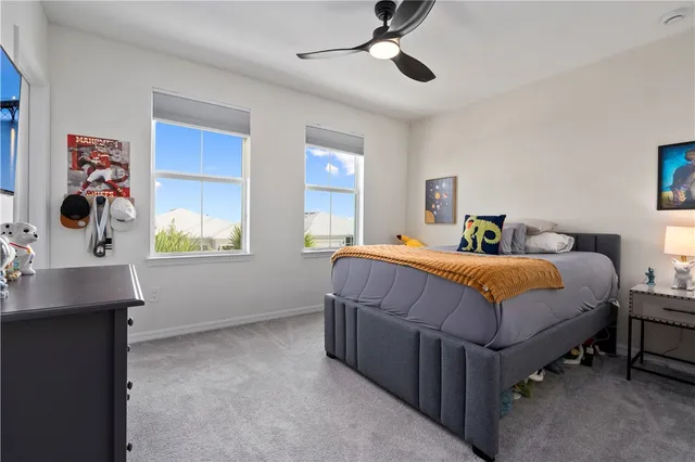 a bedroom with a large bed and a window