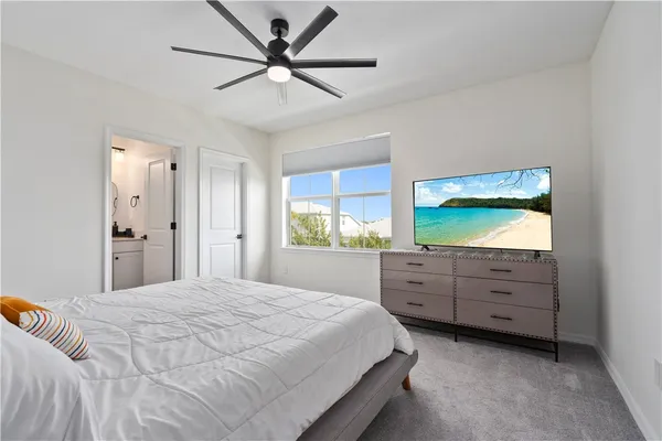 a bedroom with a large bed and a window