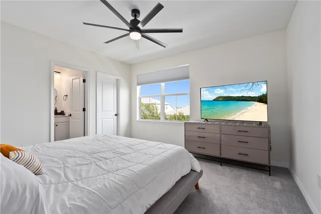 a bedroom with a large bed and a window