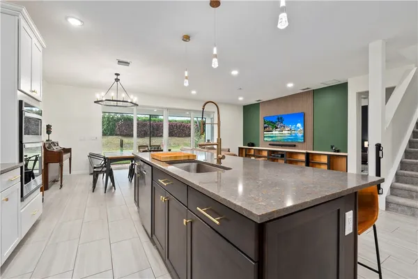 a view of kitchen island a flat screen tv