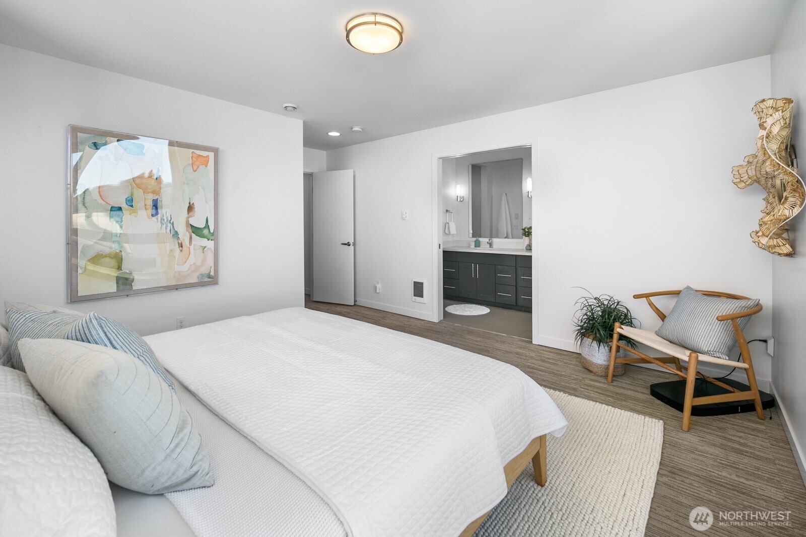 2808 14th Avenue West, Unit B Seattle, WA 98119 - Photo 13 of 39 a bedroom with a bed and a chair